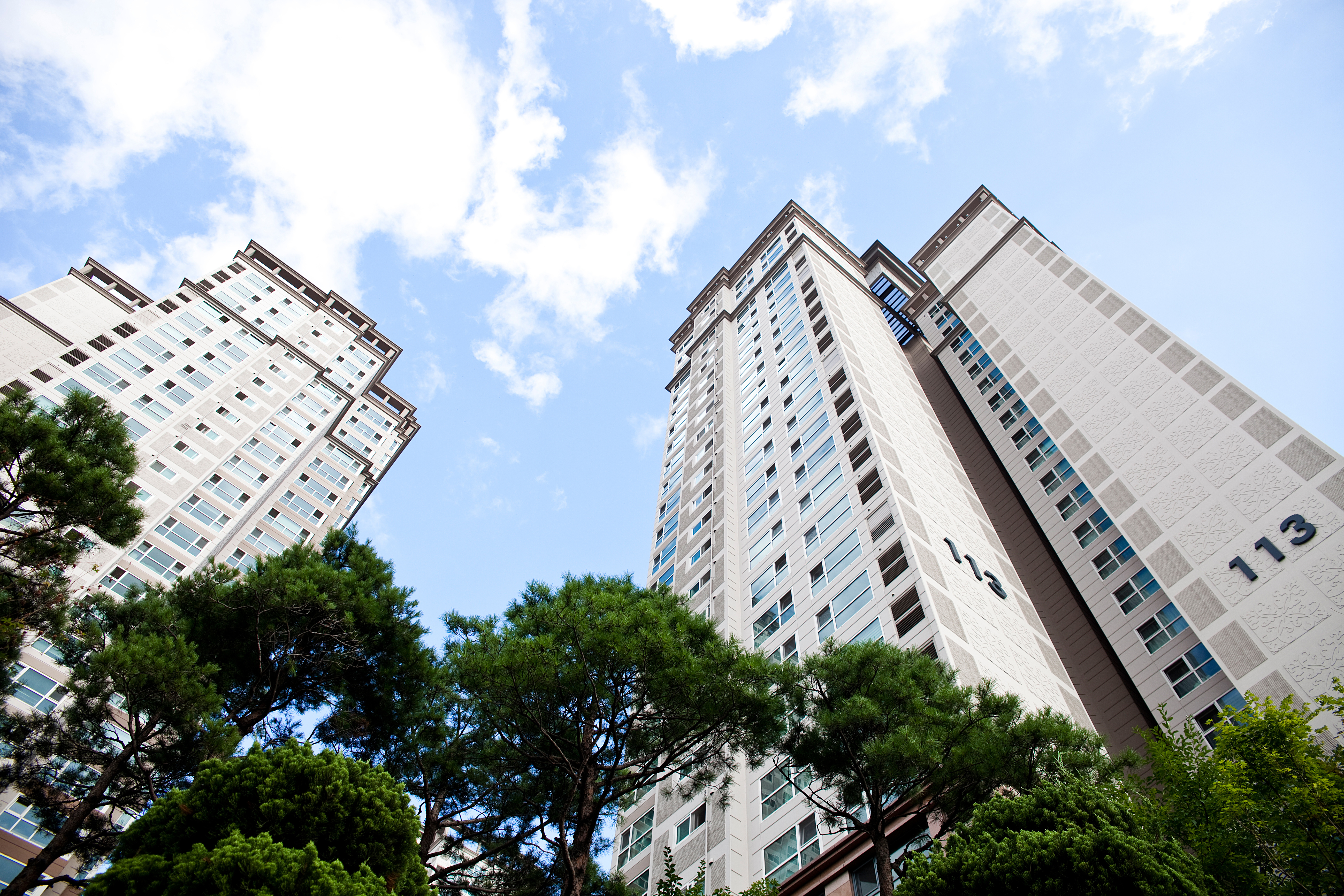 Apartment buildings viewed from below against a blue sky