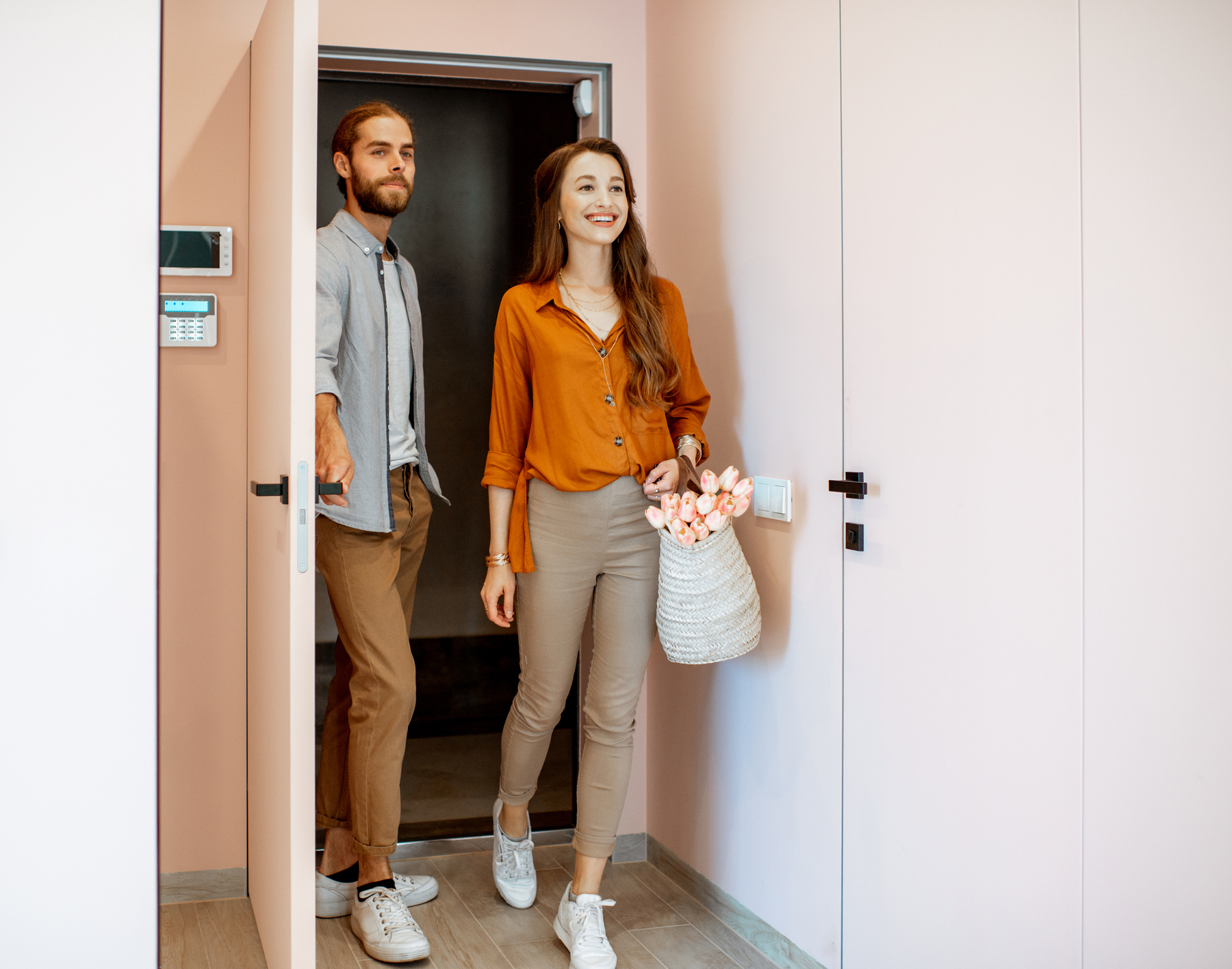 A couple entering their apartment home