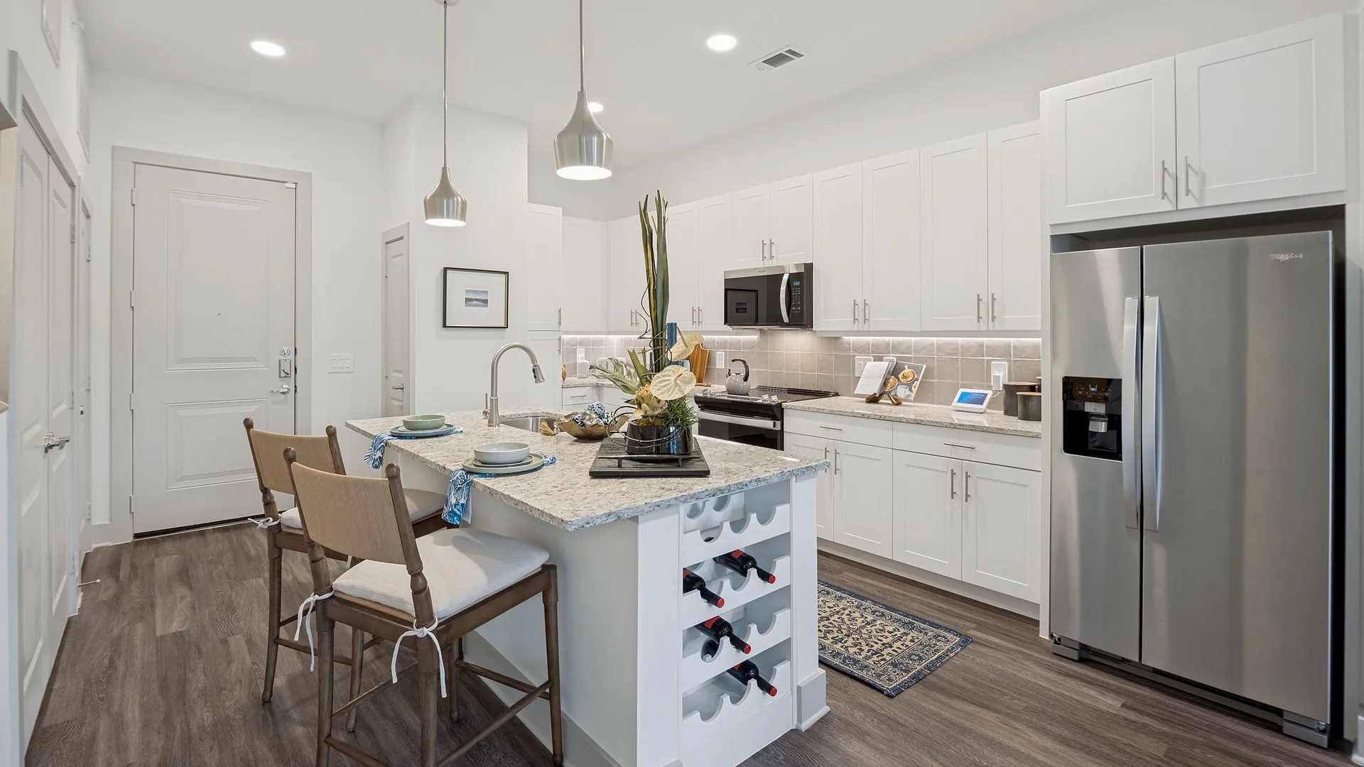Modern kitchen and entryway with cozy decor and wine storage.