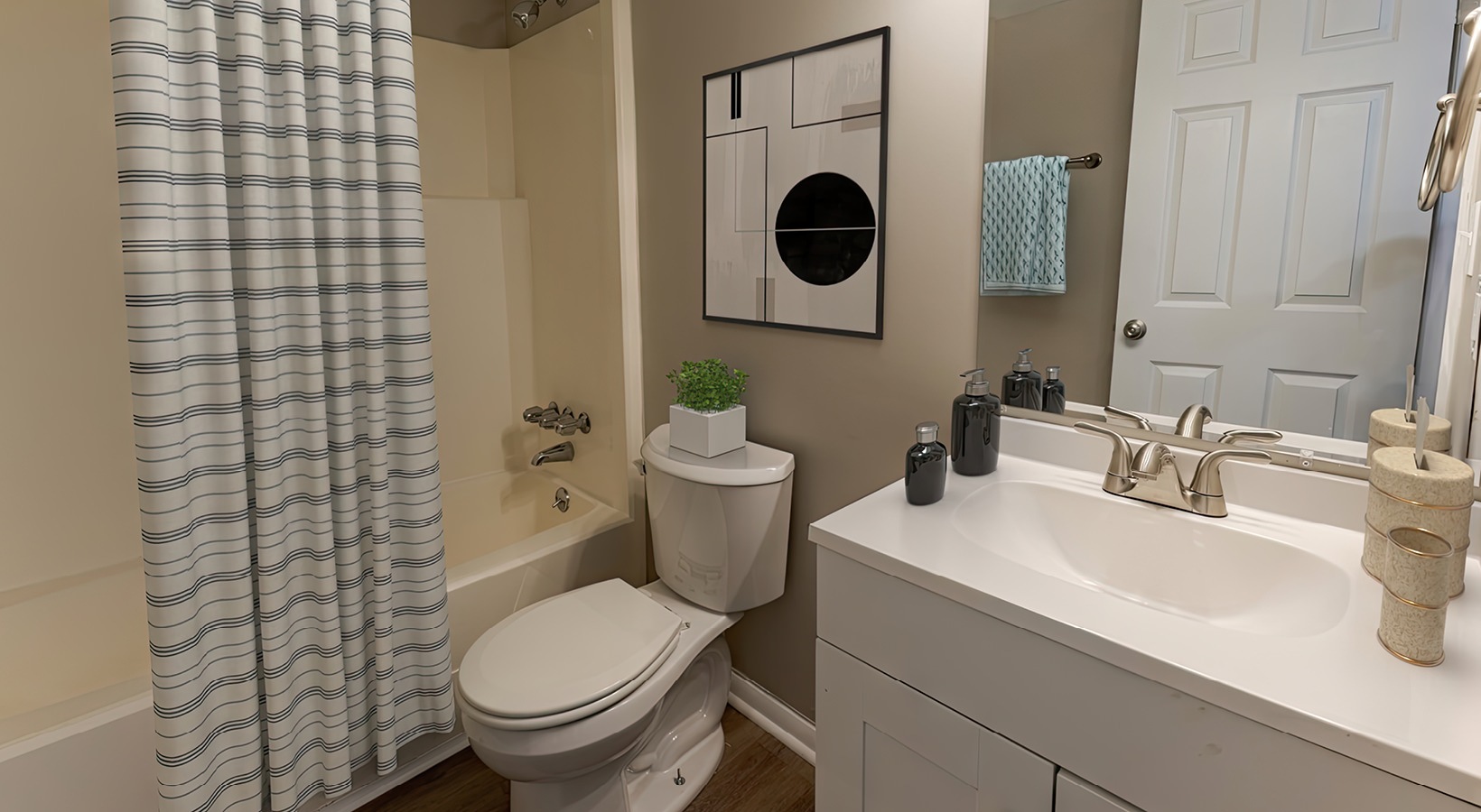 spacious bathroom with a tub, toilet and a mirror