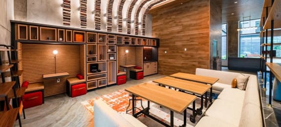 a living room with a table and a kitchen