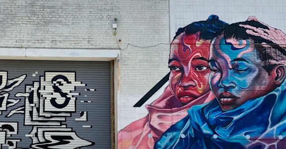 a mural of a man and a woman on the side of a building