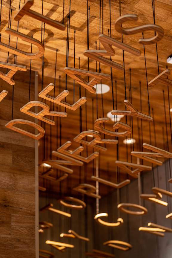 Wooden letters on a wall spelling out the word "dreams".