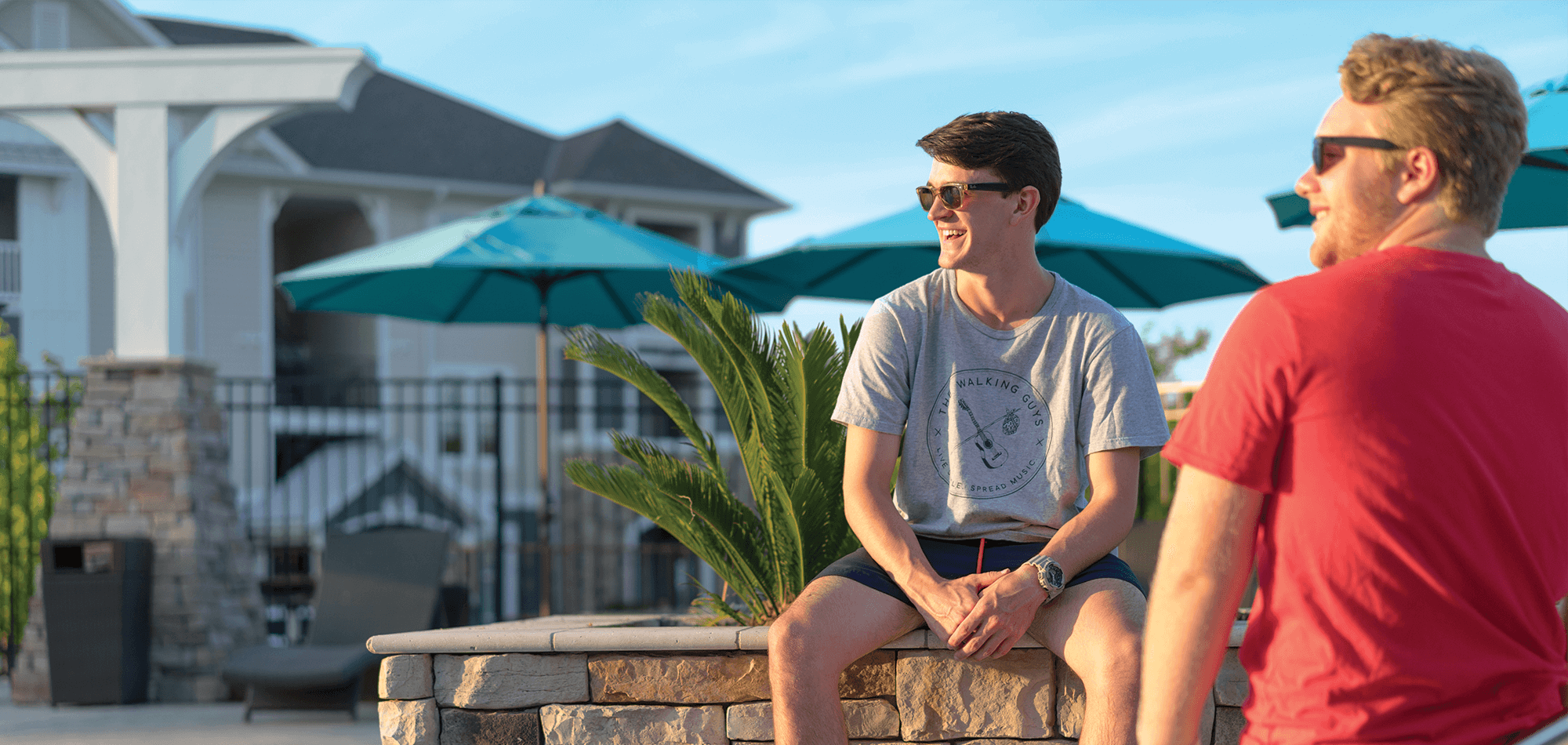 two men smiling at the Pool at the Morgan at Eastchase