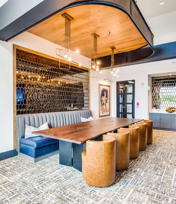 a long dining room with a long wooden table and chairs