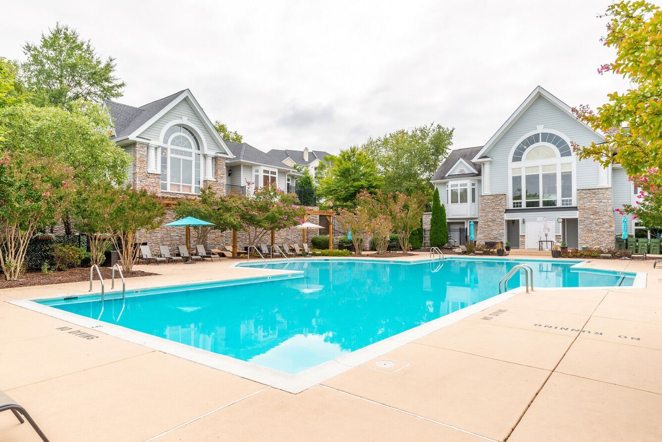 Swimming pool and sundeck with lounge chairs.