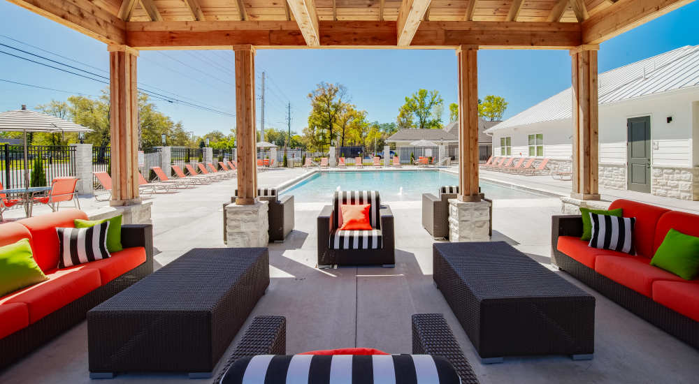 Resort-style swimming pool with seating space at Retreat at Redstone in Crestview, Florida