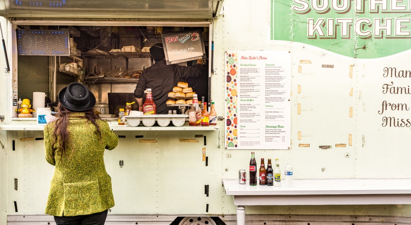 Woman ordering food at a modern food truck
