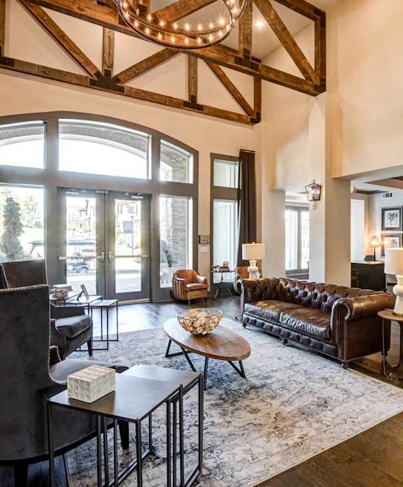 A large room with a couch, chairs, and a coffee table.
