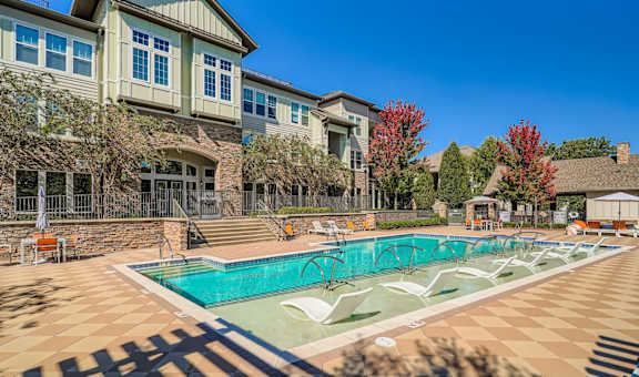 A large house with a pool in front.