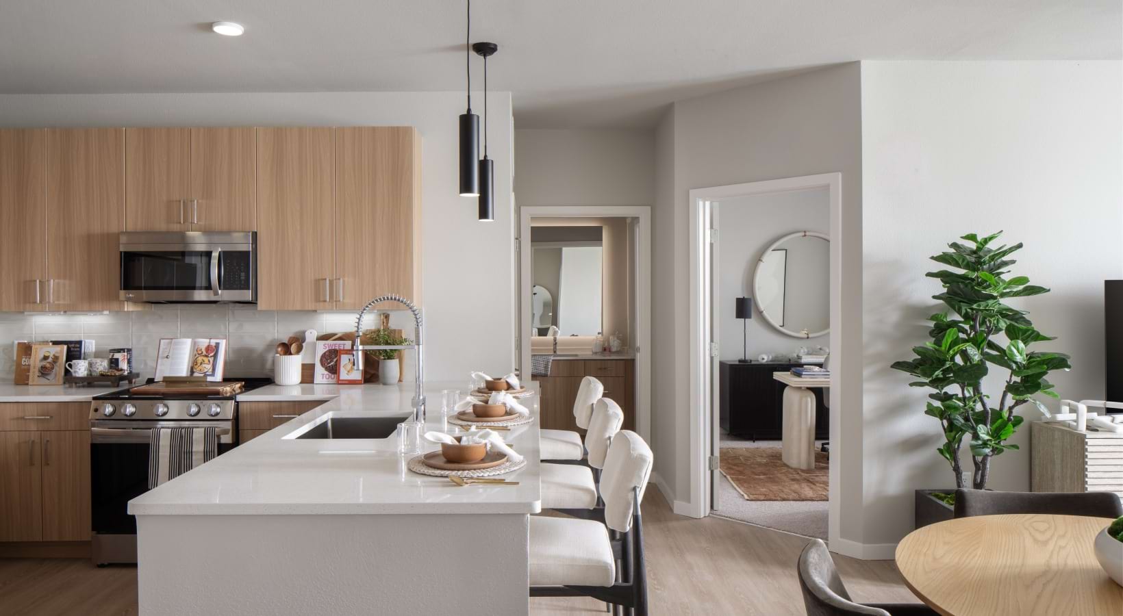 kitchen with bar stools and a plant