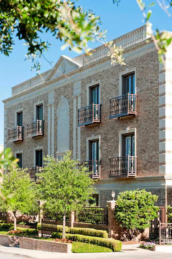 A building with a balcony and a black railing.