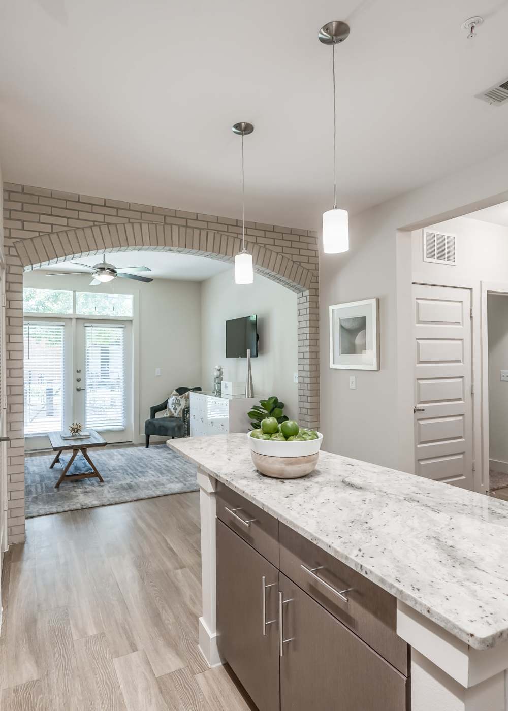 View living room with tv from kitchen at Tate Tanglewood in Houston, Texas