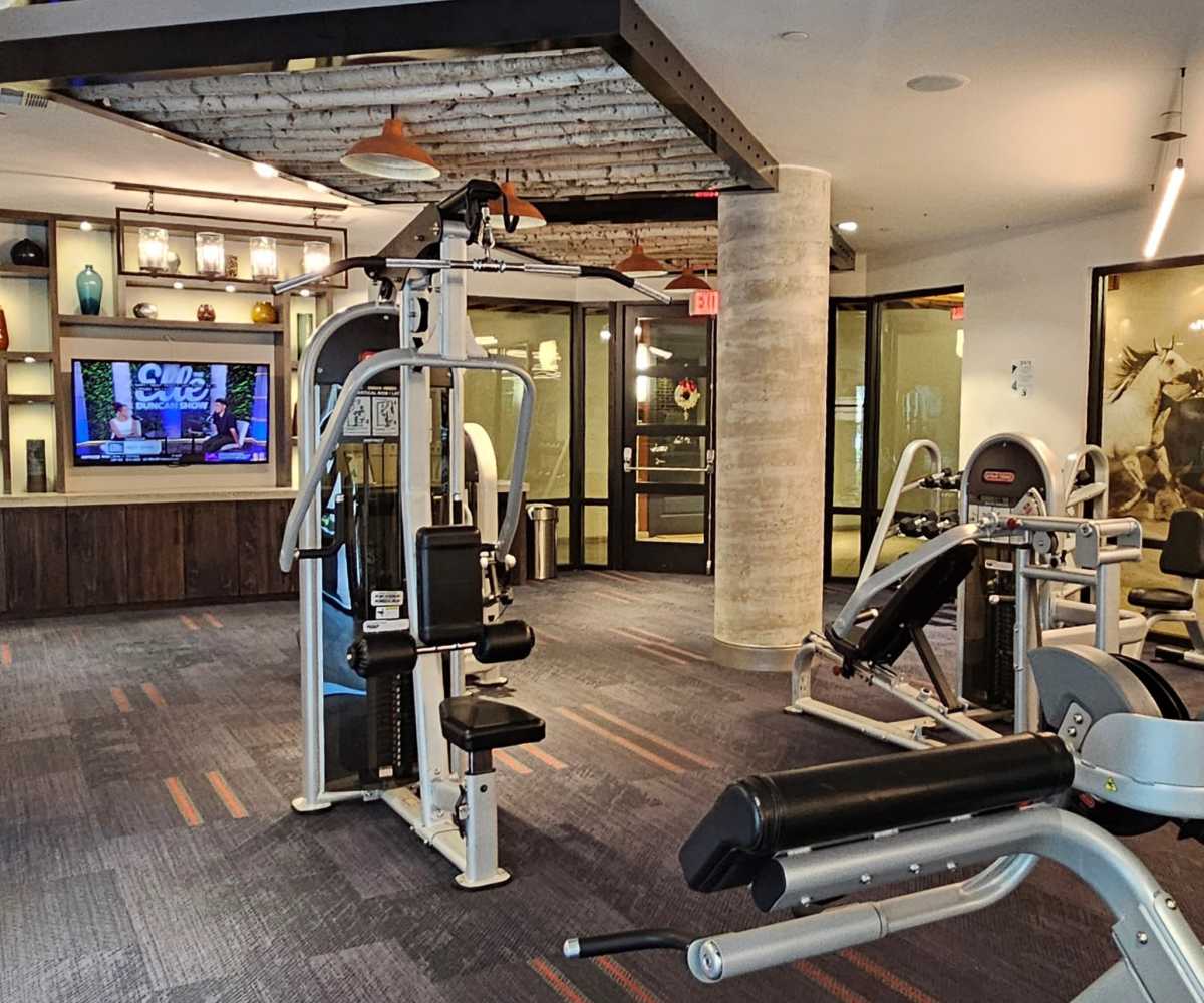 Community gym with full equipment and tv at Tate Tanglewood in Houston, Texas