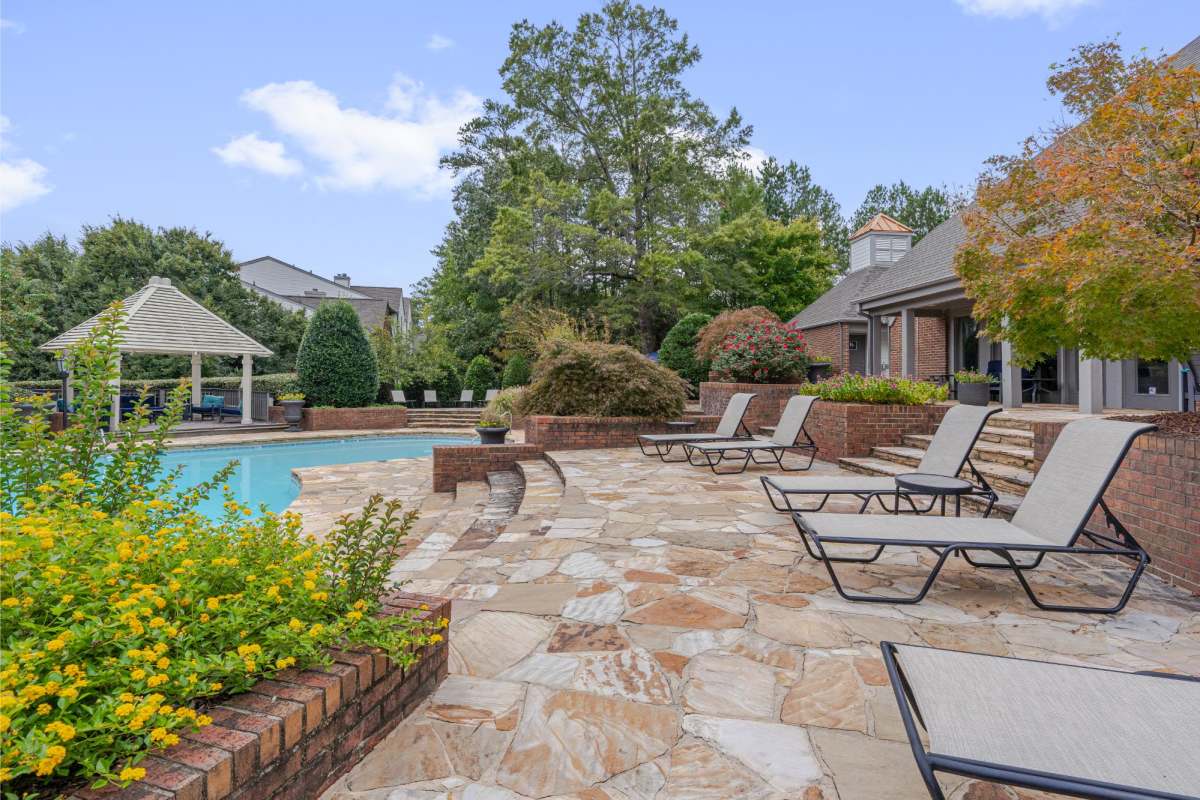 Swimming pool and patio with lounge chairs at Southpoint Estate Apartments, Durham, North Carolina