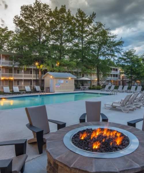 Community swimming pool with firepit at Heather Ridge Apartments in Columbia, Missouri