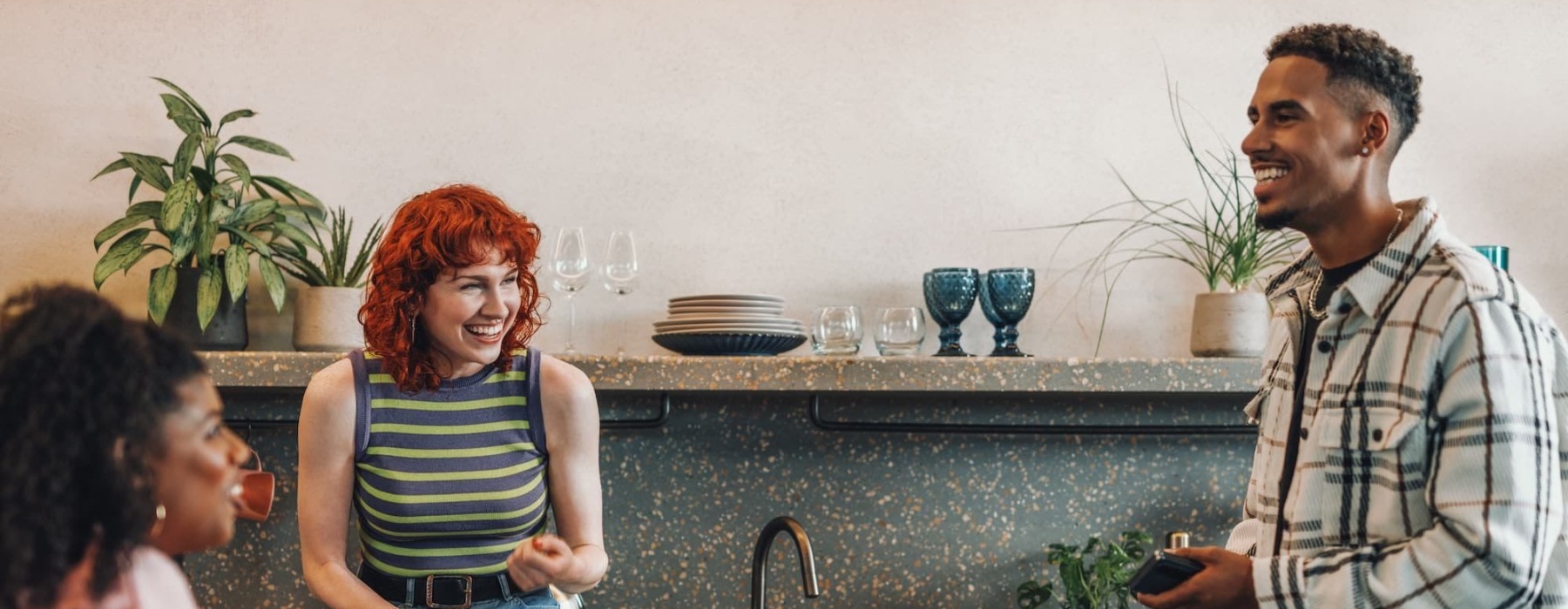friends talking in a bright kitchen