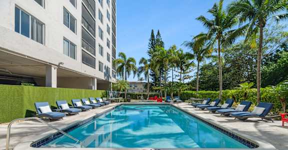 Resort-style swimming pool with sundeck at Wilton Tower pet-friendly apartments in Wilton Manors, FL.