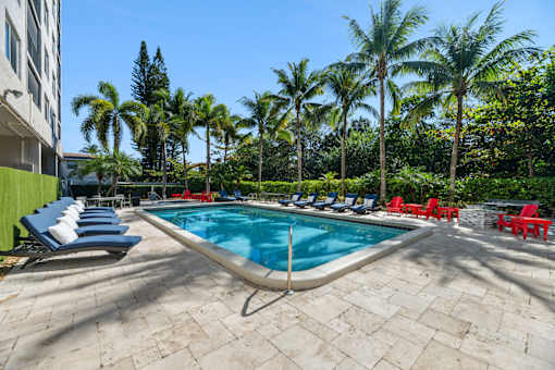 Resort-style swimming pool with sundeck at Wilton Tower pet-friendly apartments in Wilton Manors, FL.