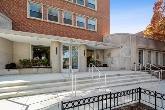 a large brick building with a staircase in front of it at Carver and Slowe Apartments, Washington Washington, DC