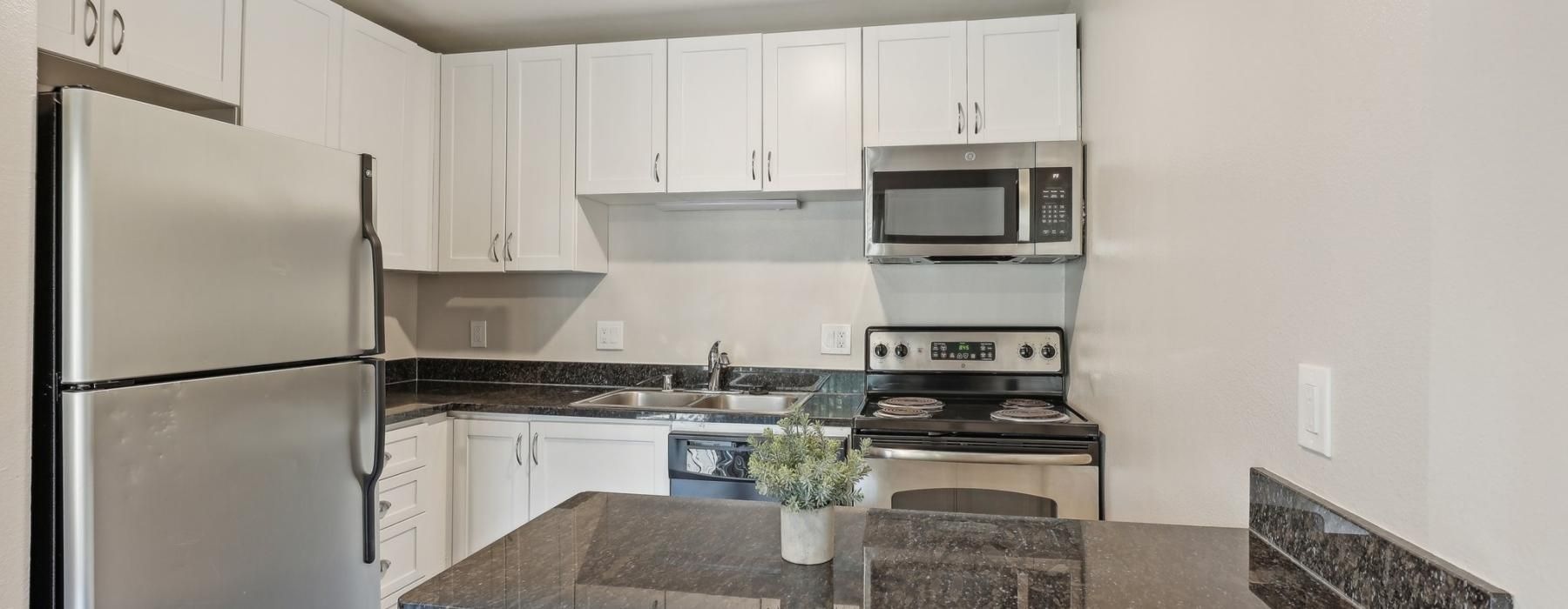 a kitchen with white cabinets