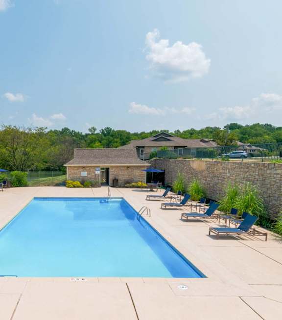 Large swimming pool surrounded by lounge chairs at Timber Lakes at Red Bridge, Kansas City, MO, 64137