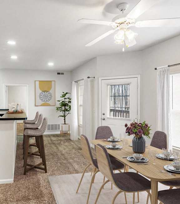 Modern kitchen with a dining table at Timber Lakes at Red Bridge, Kansas City, MO