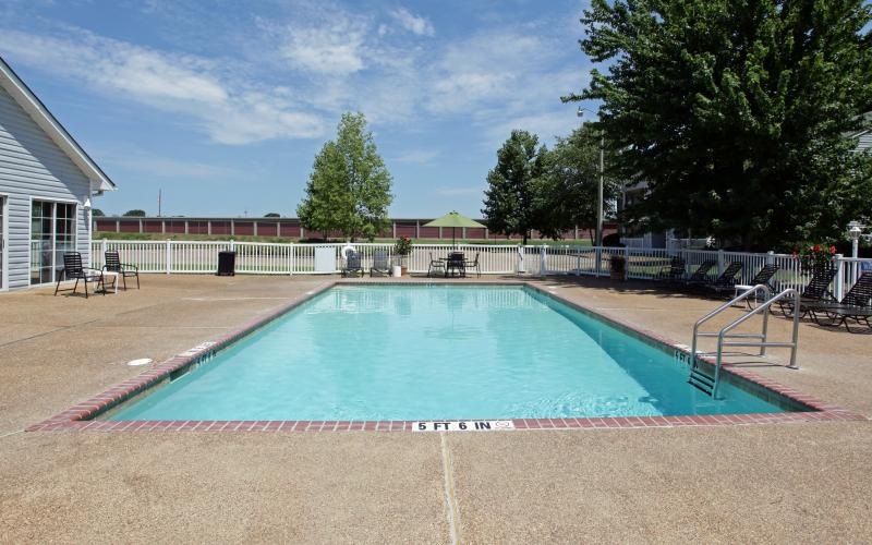 a swimming pool  with chairs surrounding it