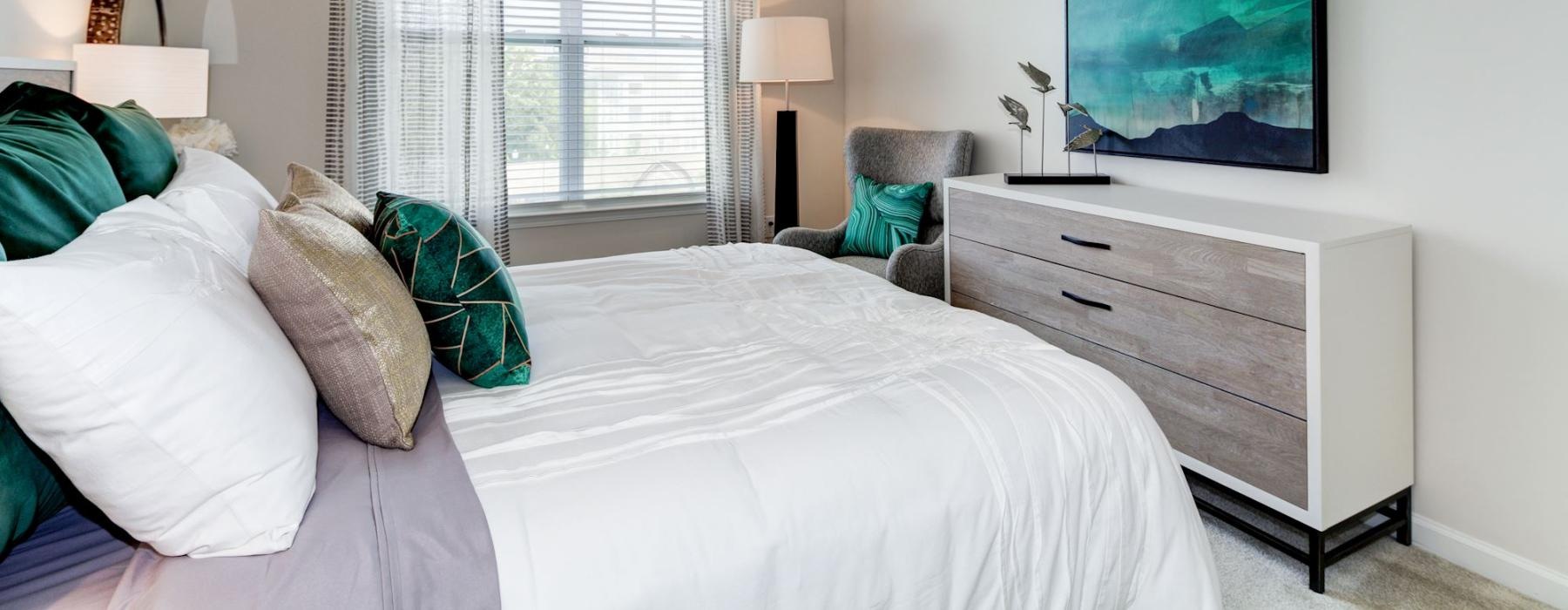 a bedroom with a fan and bed