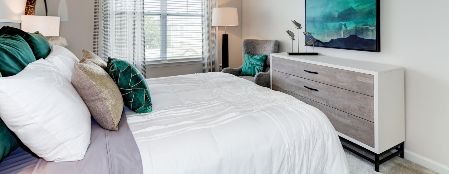 a bedroom with a fan and bed