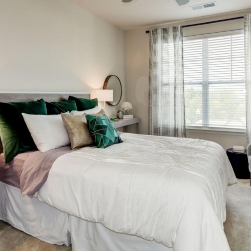 a bedroom with a bed and a fan