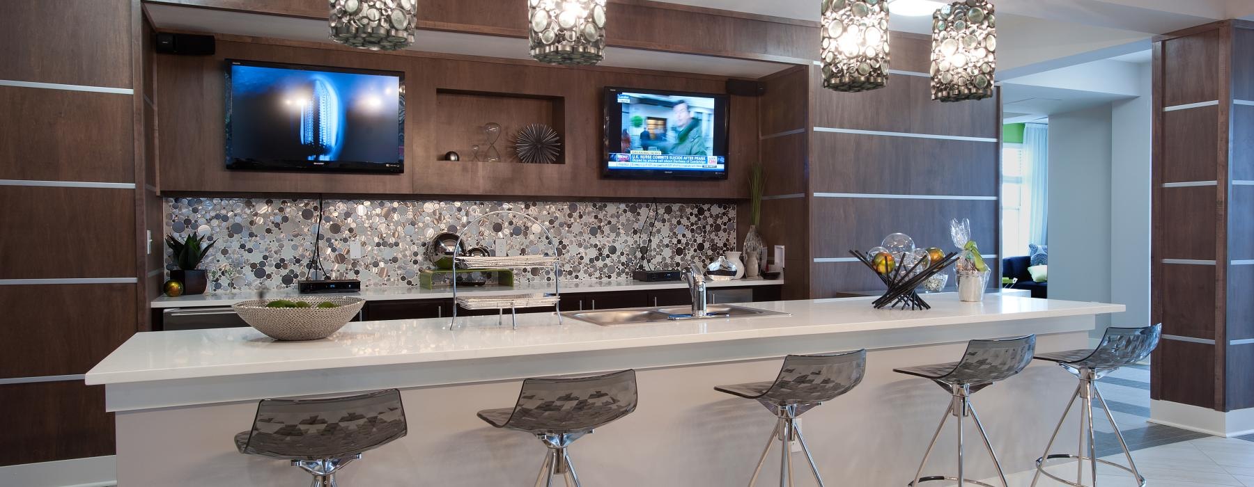 a lounge with a tv and stools