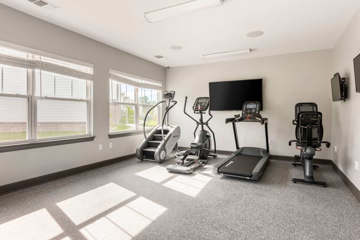 Fitness center with large windows at Jefferson Green in Louisville, Kentucky