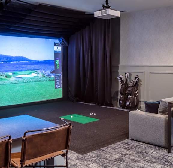 A room with a golf simulator screen at 365 Nicollet, Minneapolis, MN, Manchester