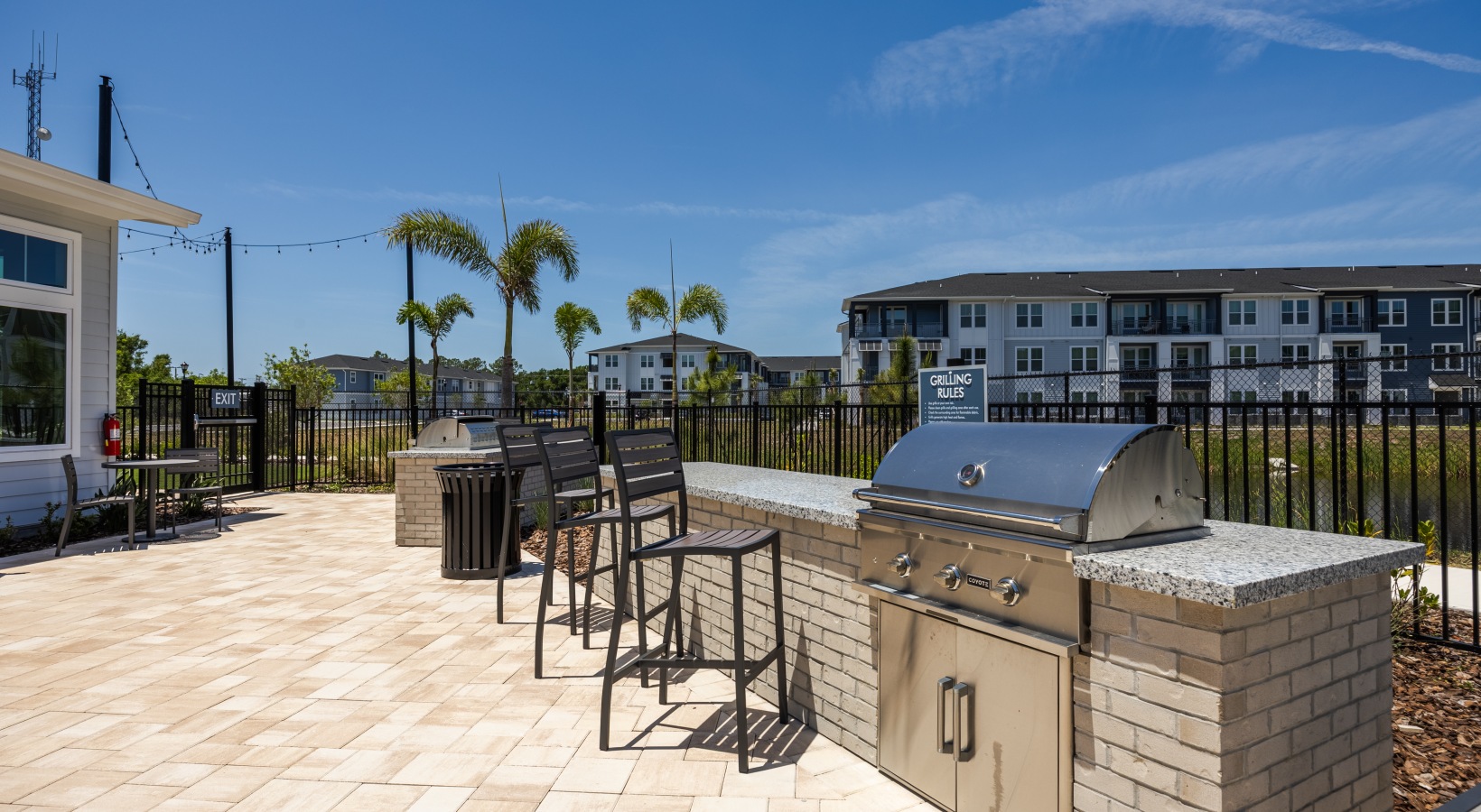 Outdoor resort-style pool at Madison Palms apartments in Ruskin FL with lounge seating and palm trees.