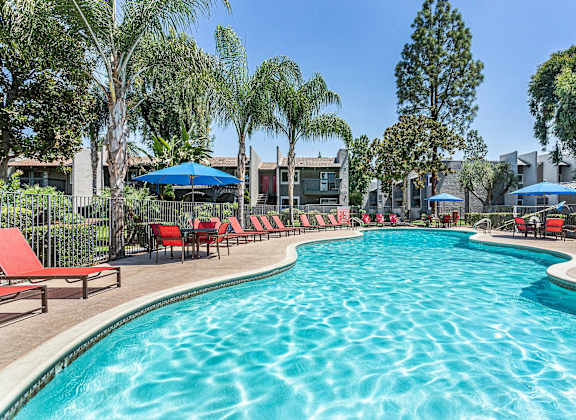swimming pool with red chairs and umbrellas at the resort at governors crossing