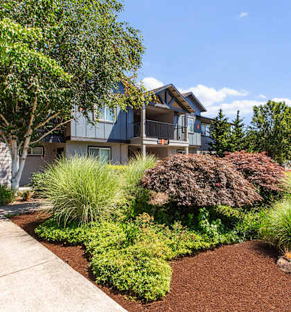 A house with a well-maintained garden in front.