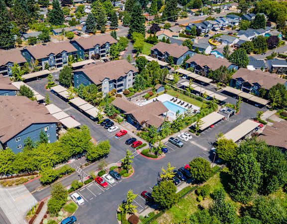 A bird's eye view of a residential area with houses and cars.