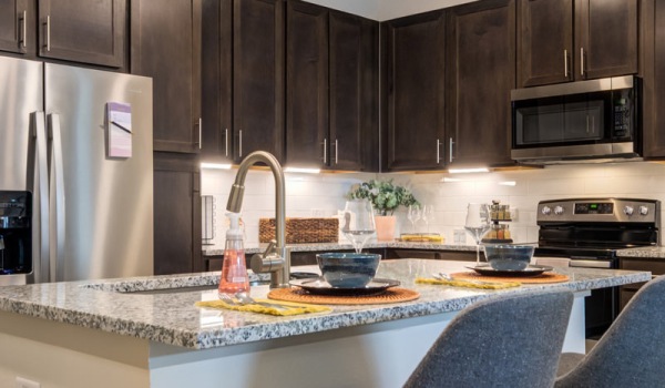 Small kitchen with island and track lighting.