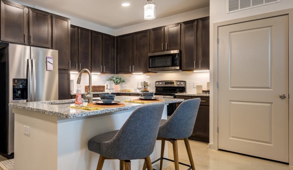 Small kitchen with island and track lighting.