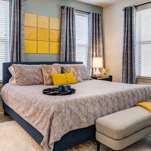 Large bedroom with windows on two walls providing plenty of natural light.