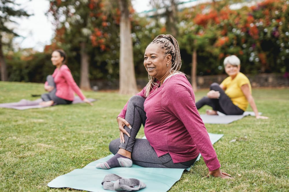 Resident practicing yoga in park near Harmony Place in Charlotte, North Carolina
