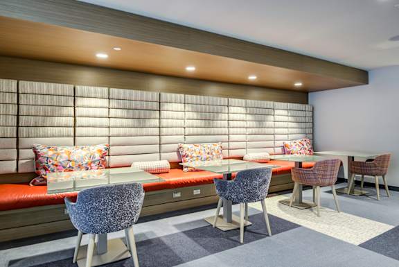 A modern dining room with a long table and chairs.