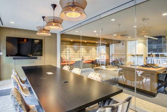 A conference room with a long table and chairs.