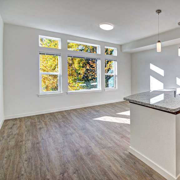 A kitchen with a large island and stainless steel appliances.