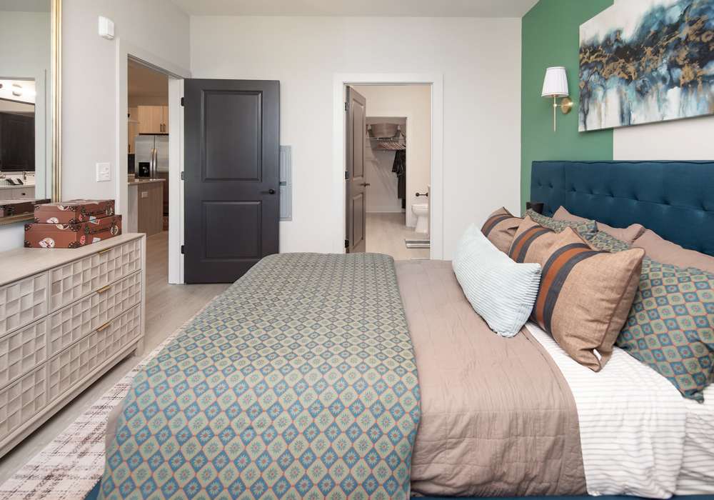 Model bedroom with wood-style flooring at Cypress Point in Mooresville, North Carolina