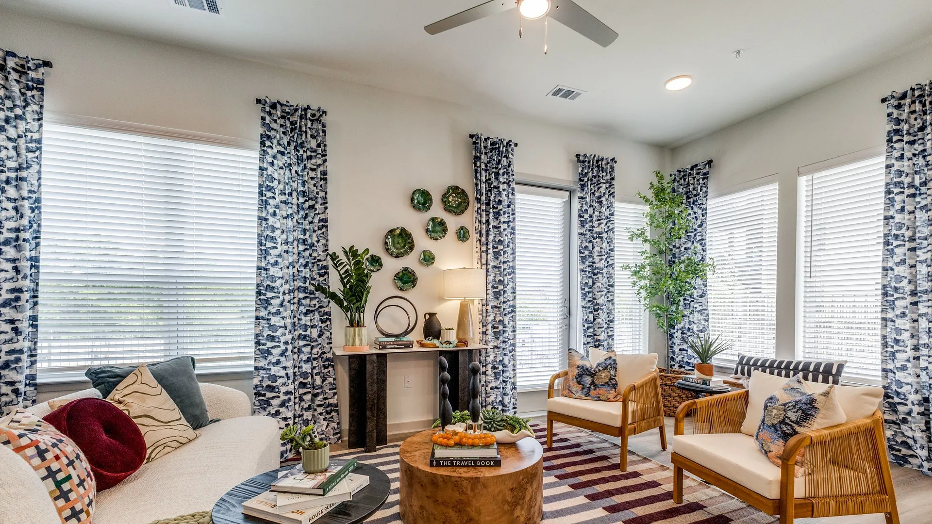 living room with sofa, armchairs, and tables