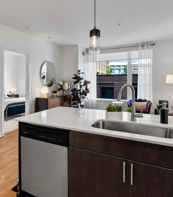 a kitchen with a sink and a door to a living room at The Parker in Portland, Oregon