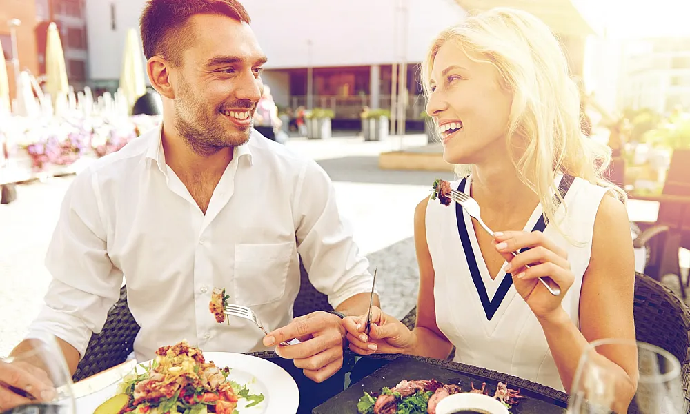 man and woman eating lunch outdoors