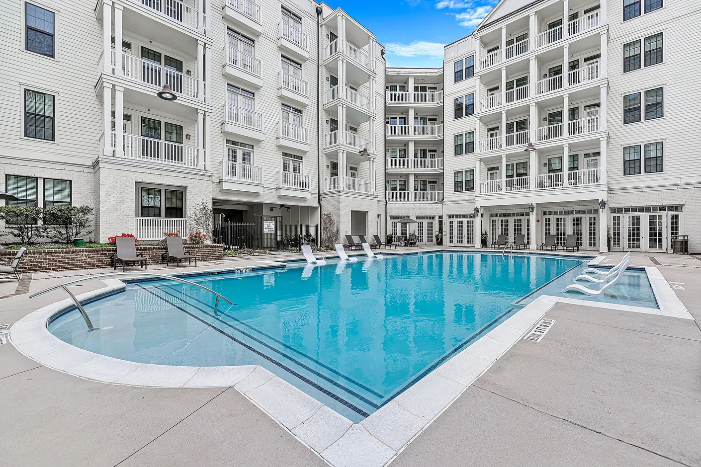 Swimming pool with lounging sun chairs